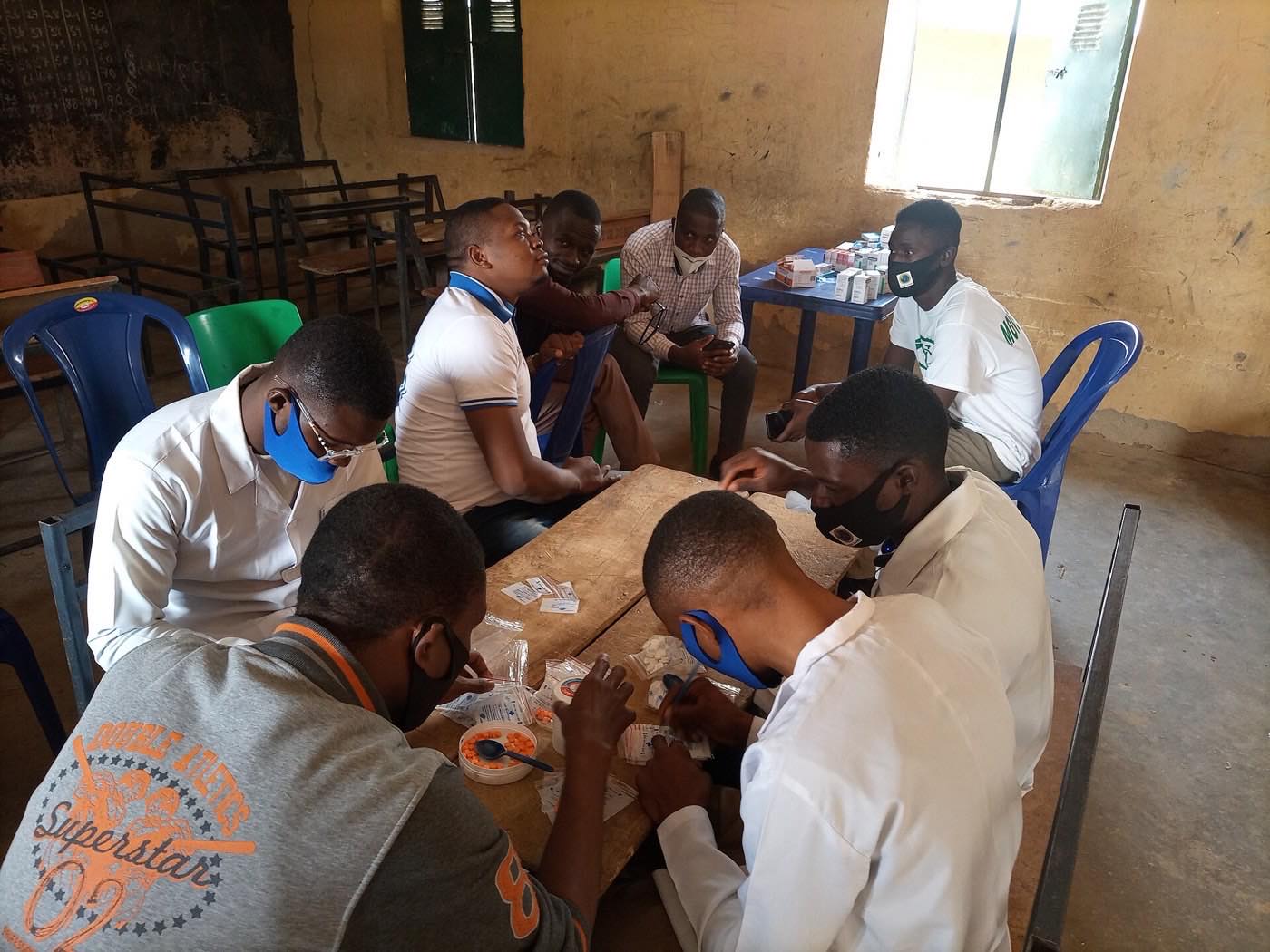 Illustrative image: Volunteers preparing medicines at a community health outreach