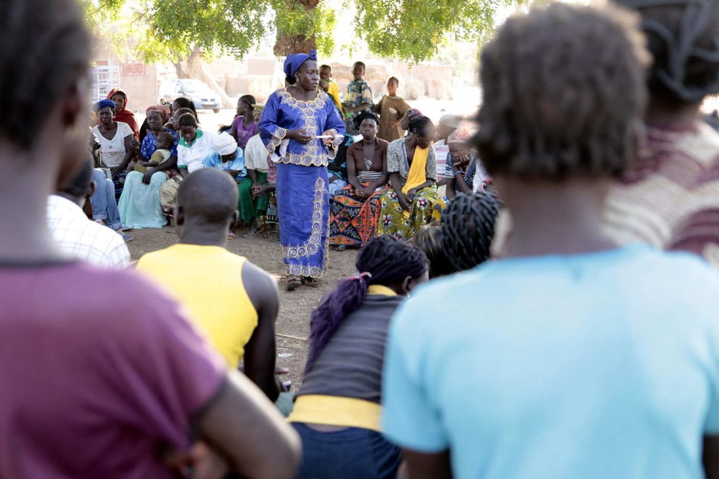 Illustrative image: community members gathered for a village dialogue session